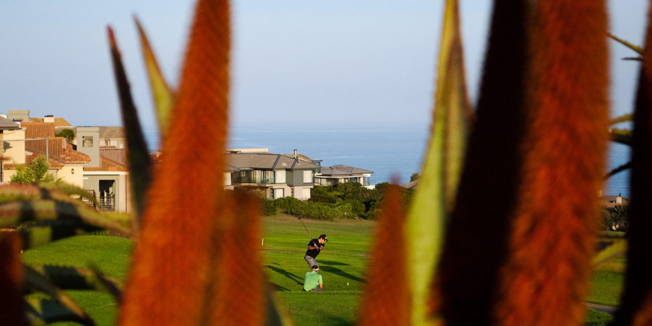 People playing golf with a sea view
