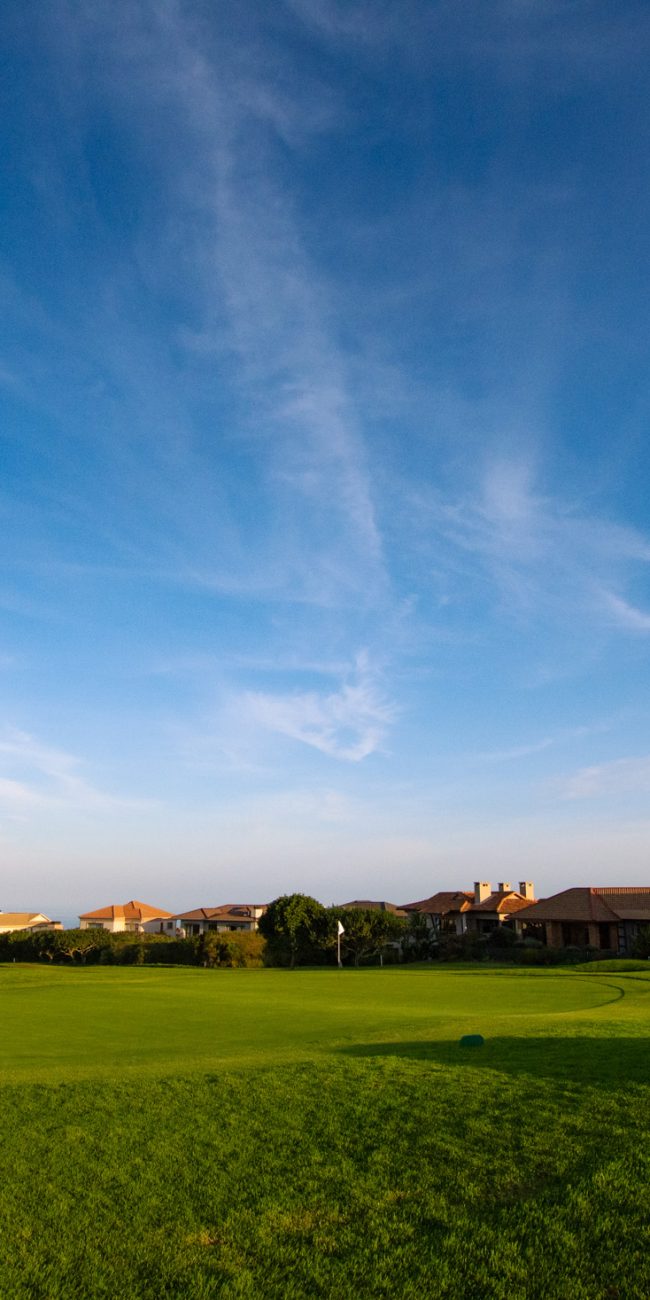 Homes near the golf greens with blue skies
